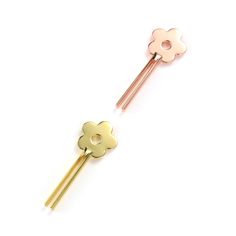 Lächelnder, blumenförmiger Tubenquetscher aus Zinklegierung Lächelnder, blumenförmiger Tubenquetscher aus Zinklegierung